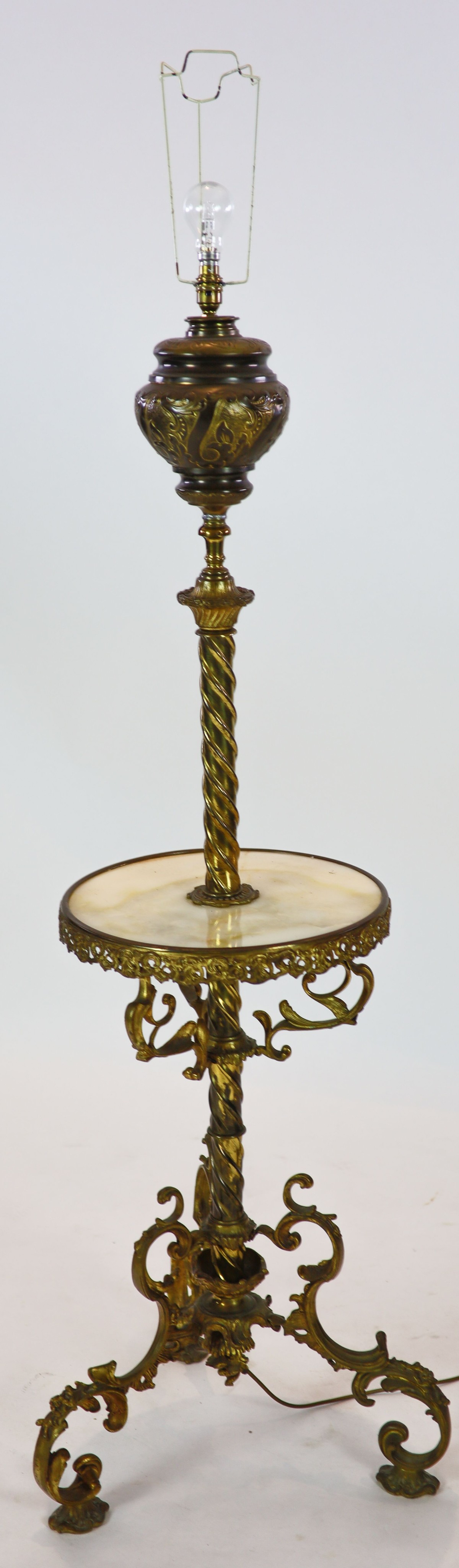 A late Victorian cast brass lamp standard, the column with an alabaster mid tier, raised on an open scrolled tripod base, converted to electricity, height 152cm